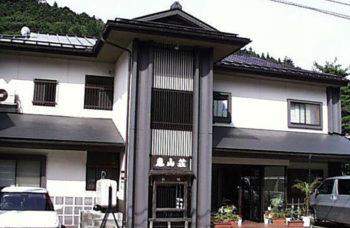 恵山荘の真っ白な壁が特徴的な建物を正面から撮影した写真